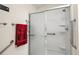 Accessible shower with grab bars and sliding glass door provides safety and convenience at 1833 Endsley Ct, The Villages, FL 32162