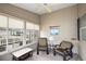 Enclosed sun room with comfortable seating, ceiling fan, and bright natural light at 1833 Endsley Ct, The Villages, FL 32162
