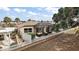 A backyard view of a single-Gathering home showcasing an enclosed porch area and landscaped surroundings at 2064 Edenton Ter, The Villages, FL 32162