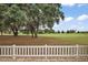 The backyard has mature trees and a well-maintained golf course view at 2064 Edenton Ter, The Villages, FL 32162