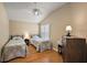 Bedroom features two twin beds, wood floors, and a ceiling fan at 2064 Edenton Ter, The Villages, FL 32162