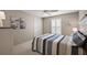 Bedroom with striped bedding, closet, ceiling fan, and neutral-colored walls at 2064 Edenton Ter, The Villages, FL 32162