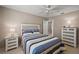 Bedroom with blue bedding, side tables, and light-colored walls at 2064 Edenton Ter, The Villages, FL 32162