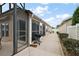 Home's exterior showing screened patio and well-maintained yard at 2064 Edenton Ter, The Villages, FL 32162