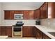 Well-equipped kitchen with stainless steel appliances, quartz countertops, and ample cabinet space at 2064 Edenton Ter, The Villages, FL 32162