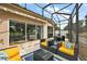 This screened patio has comfortable seating with great views of the golf course at 2064 Edenton Ter, The Villages, FL 32162