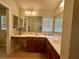 Bathroom vanity area showcasing dual sinks and functional cabinet storage at 2071 Westchester Way, The Villages, FL 32162