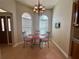 Cozy breakfast nook featuring a glass table, chandelier, and large bright windows at 2071 Westchester Way, The Villages, FL 32162