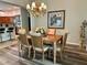 Elegant dining room with a wooden table, chandelier, and view to the kitchen at 2071 Westchester Way, The Villages, FL 32162