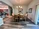 Elegant dining room with chandelier and view into kitchen at 2071 Westchester Way, The Villages, FL 32162
