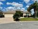 Charming home with a well-maintained lawn, landscaping, and attached two-car garage at 2071 Westchester Way, The Villages, FL 32162