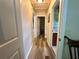 Bright hallway with hard surface floors provides access to the various rooms in the home at 2071 Westchester Way, The Villages, FL 32162