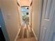 Hallway that leads to a bedroom with hard wood flooring at 2071 Westchester Way, The Villages, FL 32162