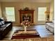 Inviting living room featuring a cozy fireplace, plush seating, and natural light at 2071 Westchester Way, The Villages, FL 32162