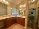 Main bathroom features double sinks and spacious countertop at 2071 Westchester Way, The Villages, FL 32162