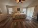 Bright main bedroom with ceiling fan, ample windows, and neutral decor at 2071 Westchester Way, The Villages, FL 32162