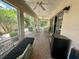 Screened-in patio area with ceiling fans, table, chairs, and mini fridge for relaxing outdoor entertaining at 2071 Westchester Way, The Villages, FL 32162
