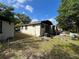 Back exterior of single-story home with some backyard items at 2107 Hollywood Ave, Eustis, FL 32726