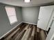 Cozy bedroom with ample light and hardwood floors at 2107 Hollywood Ave, Eustis, FL 32726