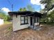 Charming single-story home with a black and white brick exterior, porch and well-maintained landscape at 2107 Hollywood Ave, Eustis, FL 32726