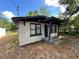 Charming single-story home with a black and white brick exterior, porch and well-maintained landscape at 2107 Hollywood Ave, Eustis, FL 32726