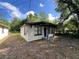 A single-story home with a covered front porch and painted white brick facade at 2107 Hollywood Ave, Eustis, FL 32726