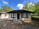Charming, single-story home featuring a covered front porch and neutral-colored brick at 2107 Hollywood Ave, Eustis, FL 32726