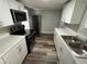 Modern kitchen featuring stainless appliances, white cabinets, and marble-look counters at 2107 Hollywood Ave, Eustis, FL 32726