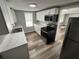 An updated kitchen featuring stainless steel appliances and bright white cabinetry with gray countertops at 2107 Hollywood Ave, Eustis, FL 32726