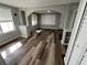 Bright living room featuring freshly painted walls and wood-look flooring at 2107 Hollywood Ave, Eustis, FL 32726