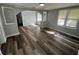 Inviting living room with new hardwood floors, neutral paint, an arched doorway and natural light at 2107 Hollywood Ave, Eustis, FL 32726