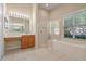 Bathroom showcasing a vanity, glass shower, and soaking tub beneath a window at 223 Crepe Myrtle Dr, Groveland, FL 34736