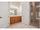 Bright bathroom features tile flooring, wooden cabinetry, and an expansive vanity at 223 Crepe Myrtle Dr, Groveland, FL 34736