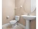 A cozy bathroom features a sink and toilet at 223 Crepe Myrtle Dr, Groveland, FL 34736