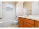 Well-lit bathroom includes a tub, toilet, and vanity with storage at 223 Crepe Myrtle Dr, Groveland, FL 34736