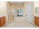 Ensuite bathroom with separate shower and garden tub, window, and dual sink vanity at 223 Crepe Myrtle Dr, Groveland, FL 34736