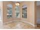 Cozy breakfast nook featuring tile floors, decorative lighting, and bright windows with views of the lush outdoor scenery at 223 Crepe Myrtle Dr, Groveland, FL 34736