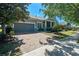 Attractive home featuring a two-car garage and a charming front porch at 223 Crepe Myrtle Dr, Groveland, FL 34736