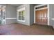 Charming front porch with brick flooring, a double-door entrance and large window with white trim at 223 Crepe Myrtle Dr, Groveland, FL 34736