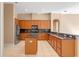 Well-equipped kitchen with stainless steel appliances, granite countertops, and wood cabinetry at 223 Crepe Myrtle Dr, Groveland, FL 34736