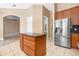 Kitchen with island, stainless steel refrigerator, and tile flooring at 223 Crepe Myrtle Dr, Groveland, FL 34736