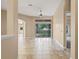 Open living area featuring neutral colors, tile flooring, and sliding glass doors to the backyard at 223 Crepe Myrtle Dr, Groveland, FL 34736