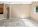 Bright living room with tile flooring, archway details, and access to the kitchen and outdoor areas at 223 Crepe Myrtle Dr, Groveland, FL 34736