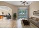 Bright living room featuring tile floors, neutral walls, and sliding glass doors to the outdoors at 223 Crepe Myrtle Dr, Groveland, FL 34736