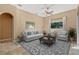 Comfortable living room with neutral furniture, tile floors, and a large window for natural light at 223 Crepe Myrtle Dr, Groveland, FL 34736