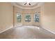 Spacious main bedroom with carpet flooring, trey ceilings and lots of natural light at 223 Crepe Myrtle Dr, Groveland, FL 34736
