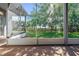 View from the screened patio of a brick surface overlooking a lush, green lawn and mature trees at 223 Crepe Myrtle Dr, Groveland, FL 34736