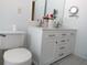 Bathroom with dual sink vanity, white cabinets and brushed nickel hardware at 223 Lady Diana Dr, Davenport, FL 33837