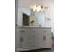 Bright bathroom with a double sink vanity, sleek hardware, and stylish lighting at 223 Lady Diana Dr, Davenport, FL 33837