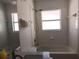 Bright bathroom featuring tub, shower, toilet, and a modern vanity with a marble countertop and chrome fixtures at 223 Lady Diana Dr, Davenport, FL 33837